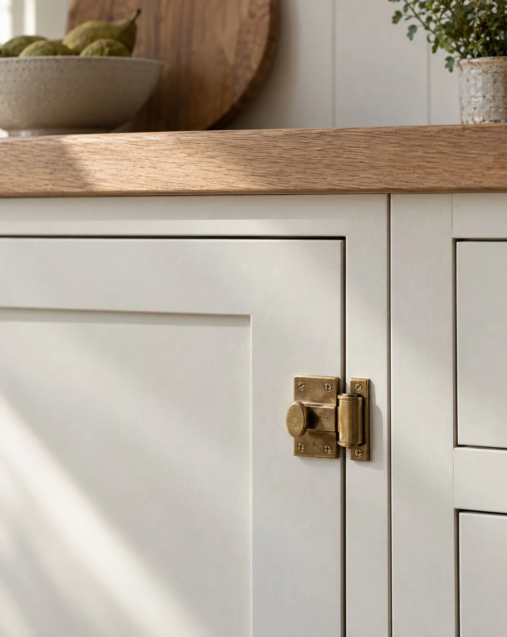 Painted inset cabinet door with an even reveal and a solid brass latch