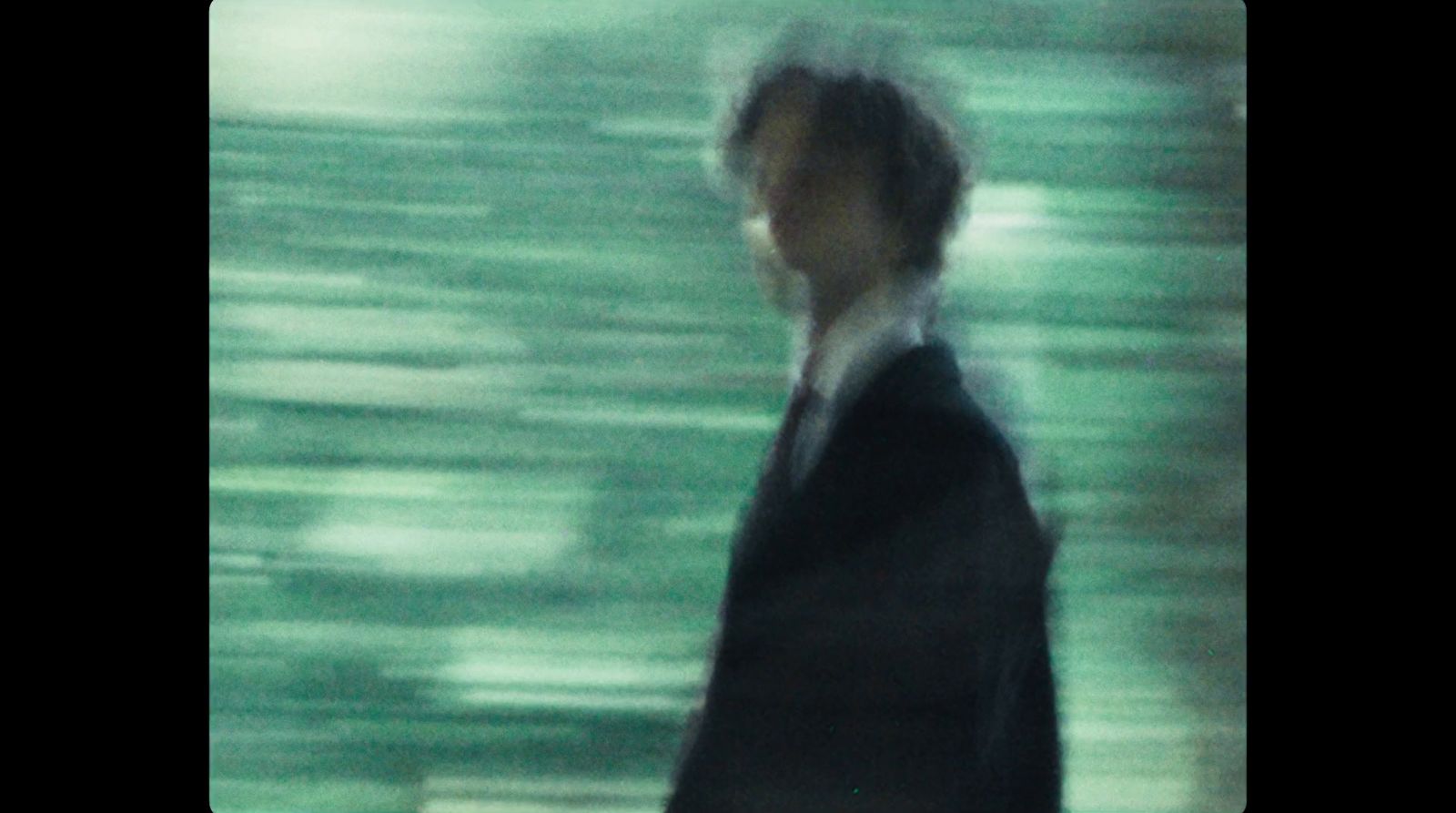 a blurry photo of a man in a suit