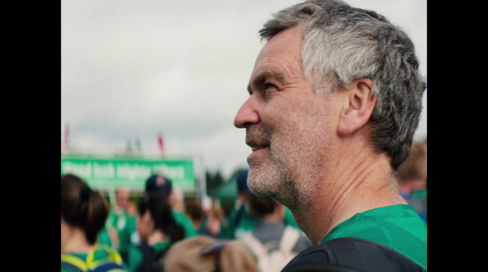 a man with grey hair and a green shirt