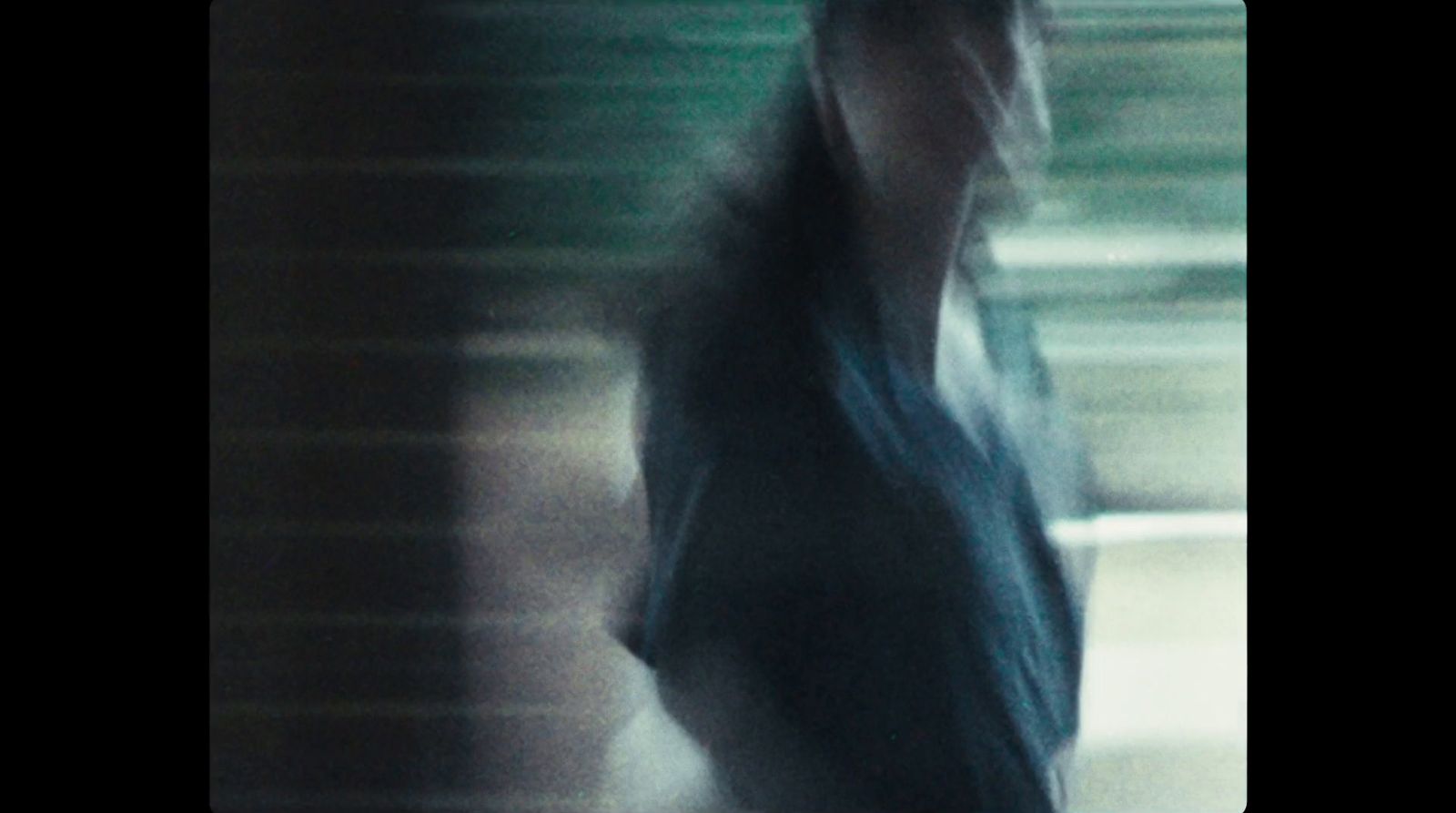 a blurry photo of a man walking down a street