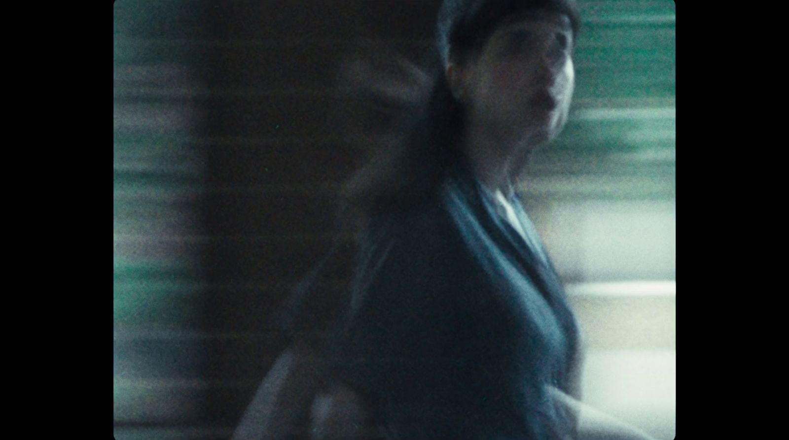 a blurry photo of a woman walking down a street