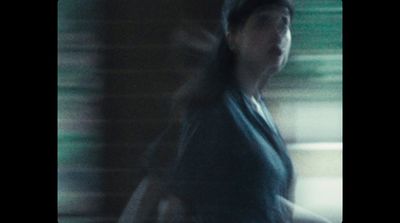 a blurry photo of a woman walking down a street