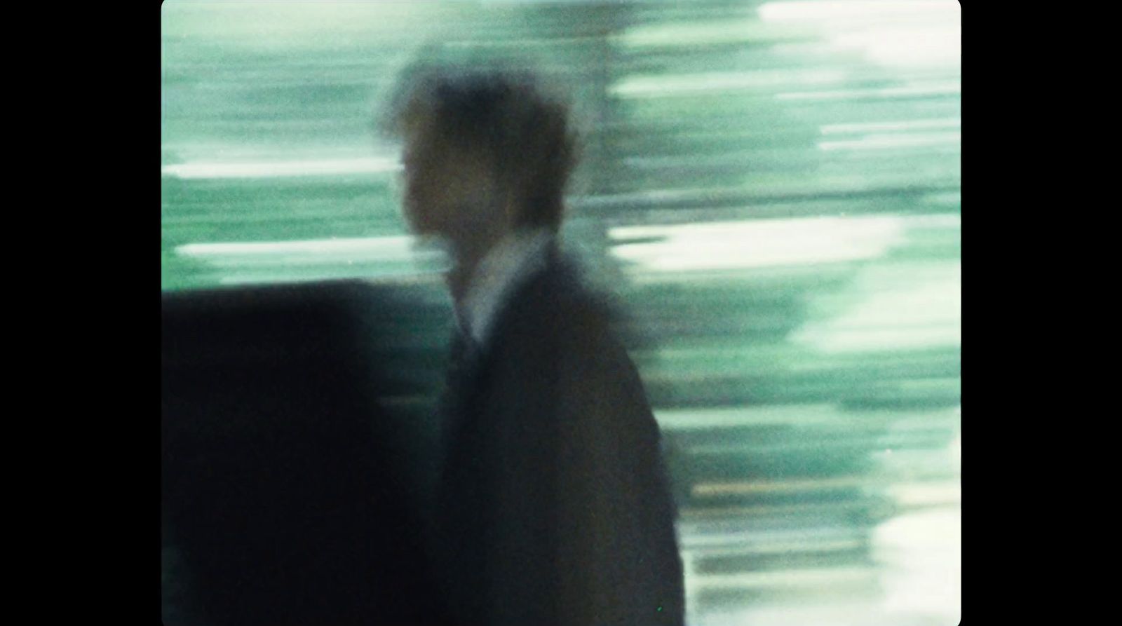 a blurry photo of a man in a suit and tie