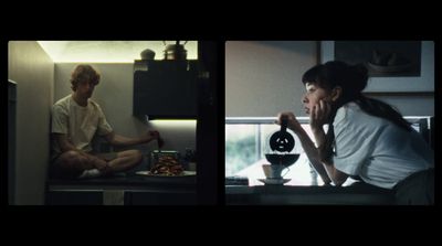 a man and a woman sitting on a kitchen counter