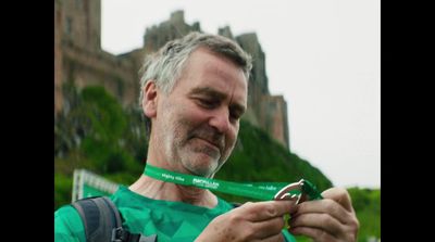 a man with a green ribbon around his neck