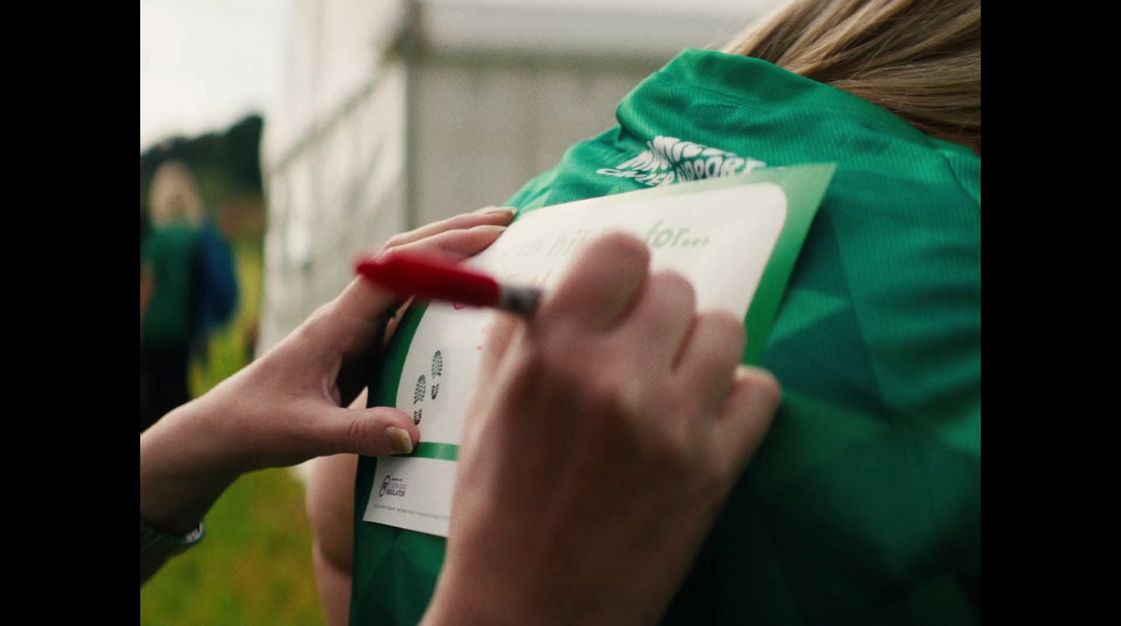 a person writing on a piece of paper