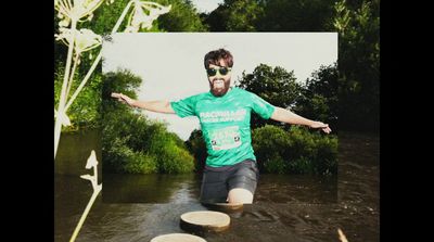 a man in a green shirt is in the water