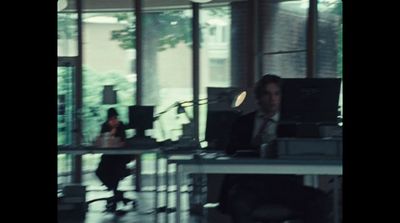 a man sitting at a desk in an office