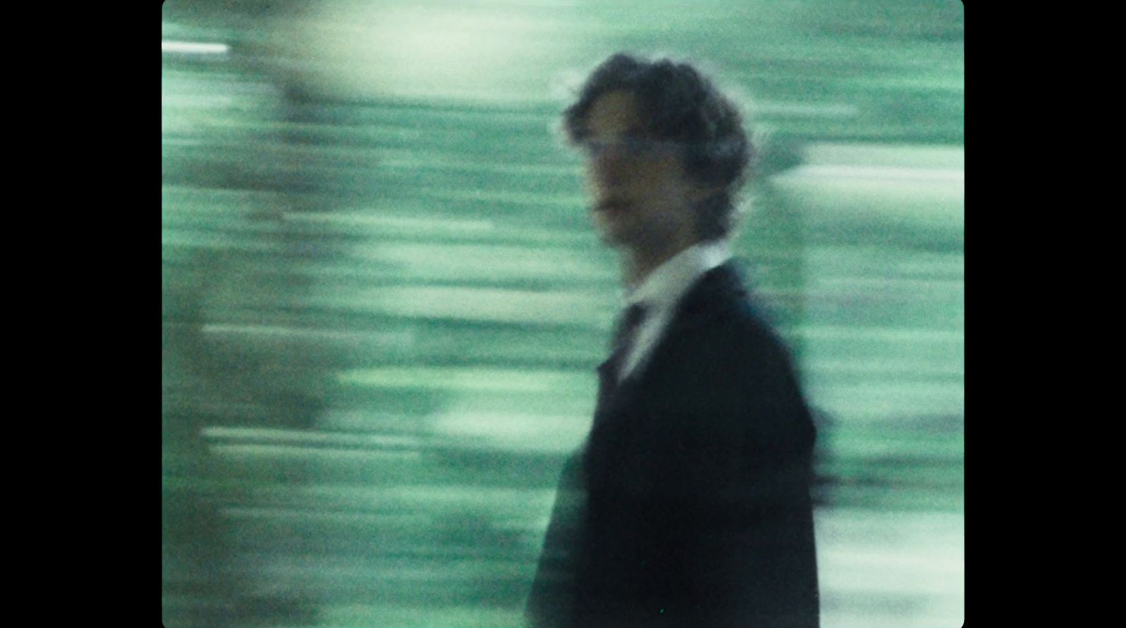 a blurry photo of a man in a suit