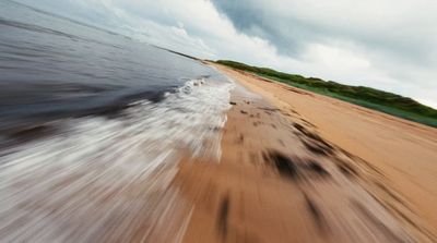 a view of a beach from a moving vehicle