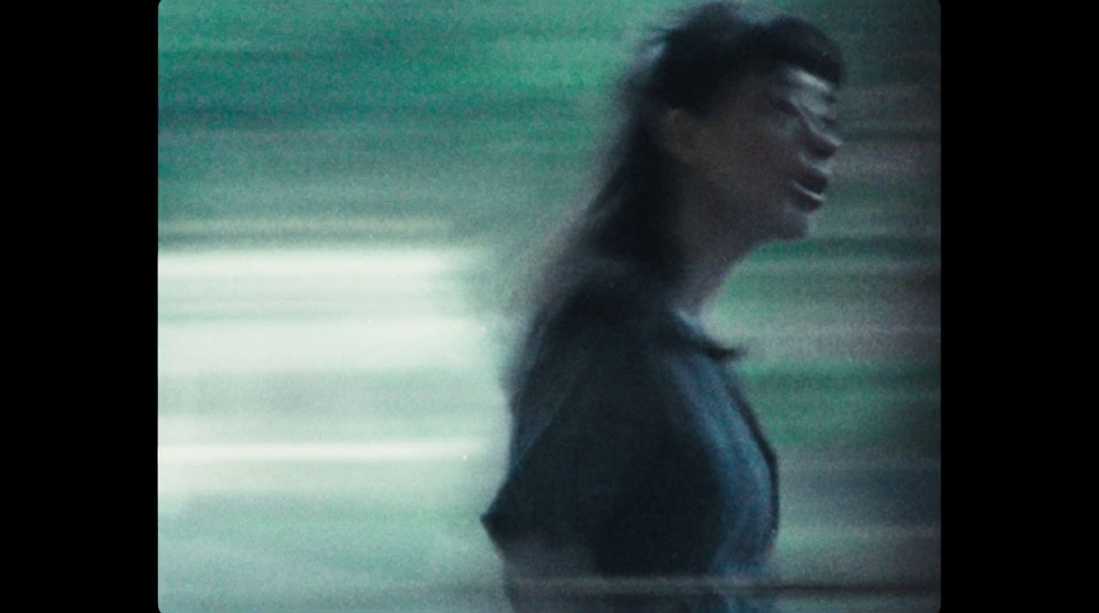 a blurry photo of a woman walking down a street