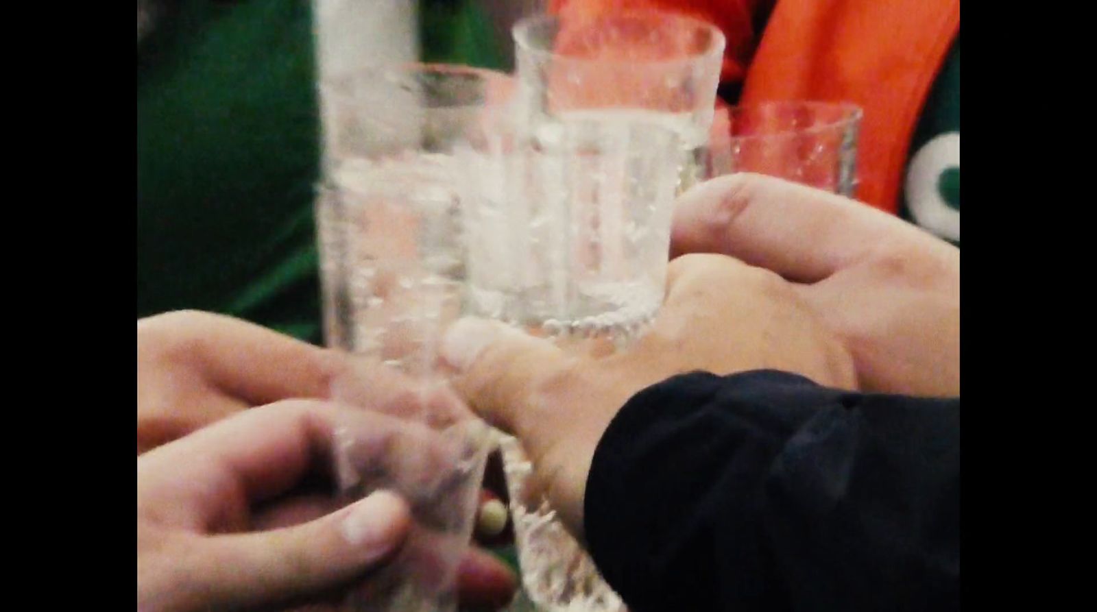 a group of people holding glasses filled with water