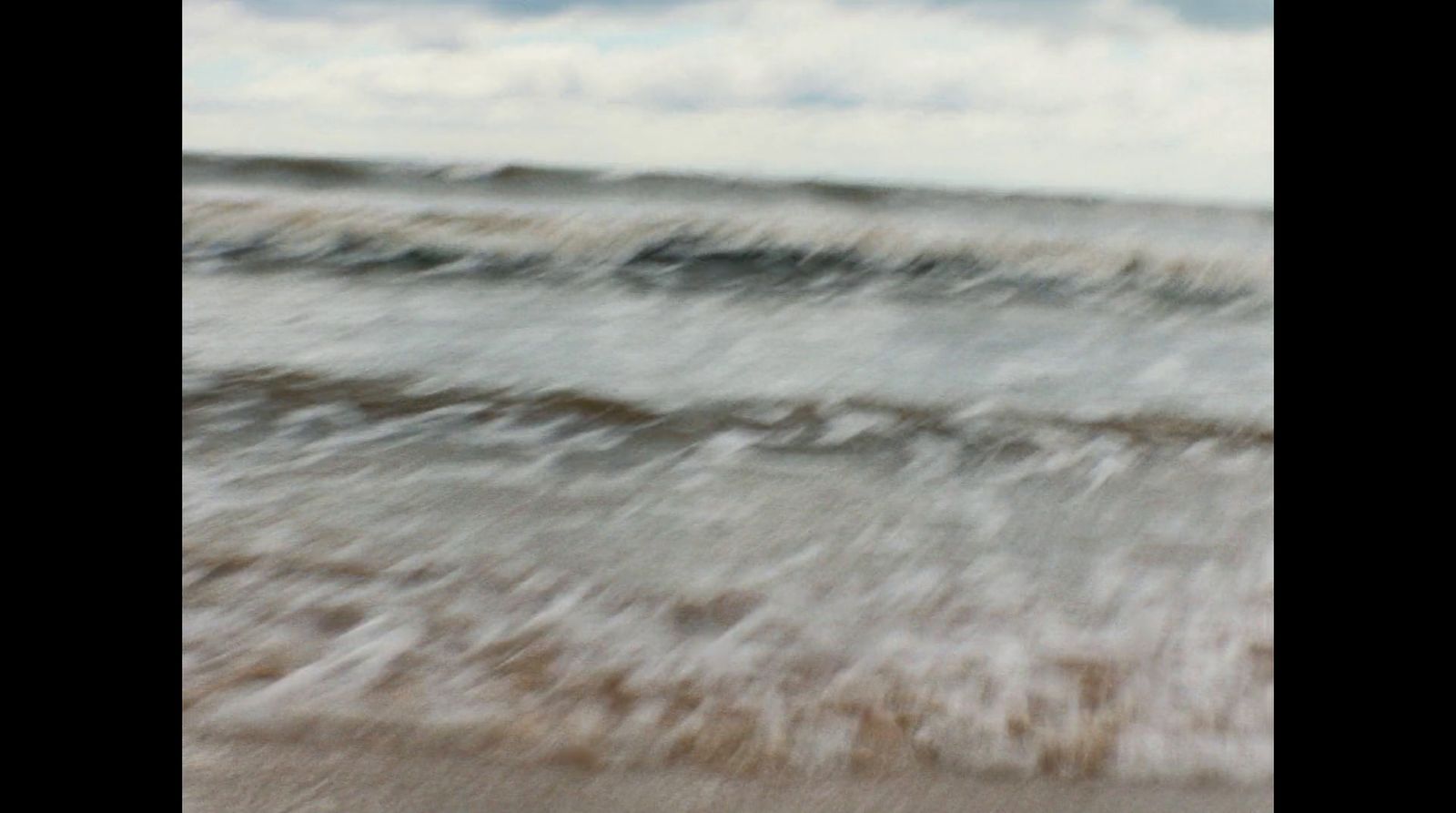 a blurry photo of a beach with waves