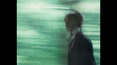 a blurry photo of a man in a suit