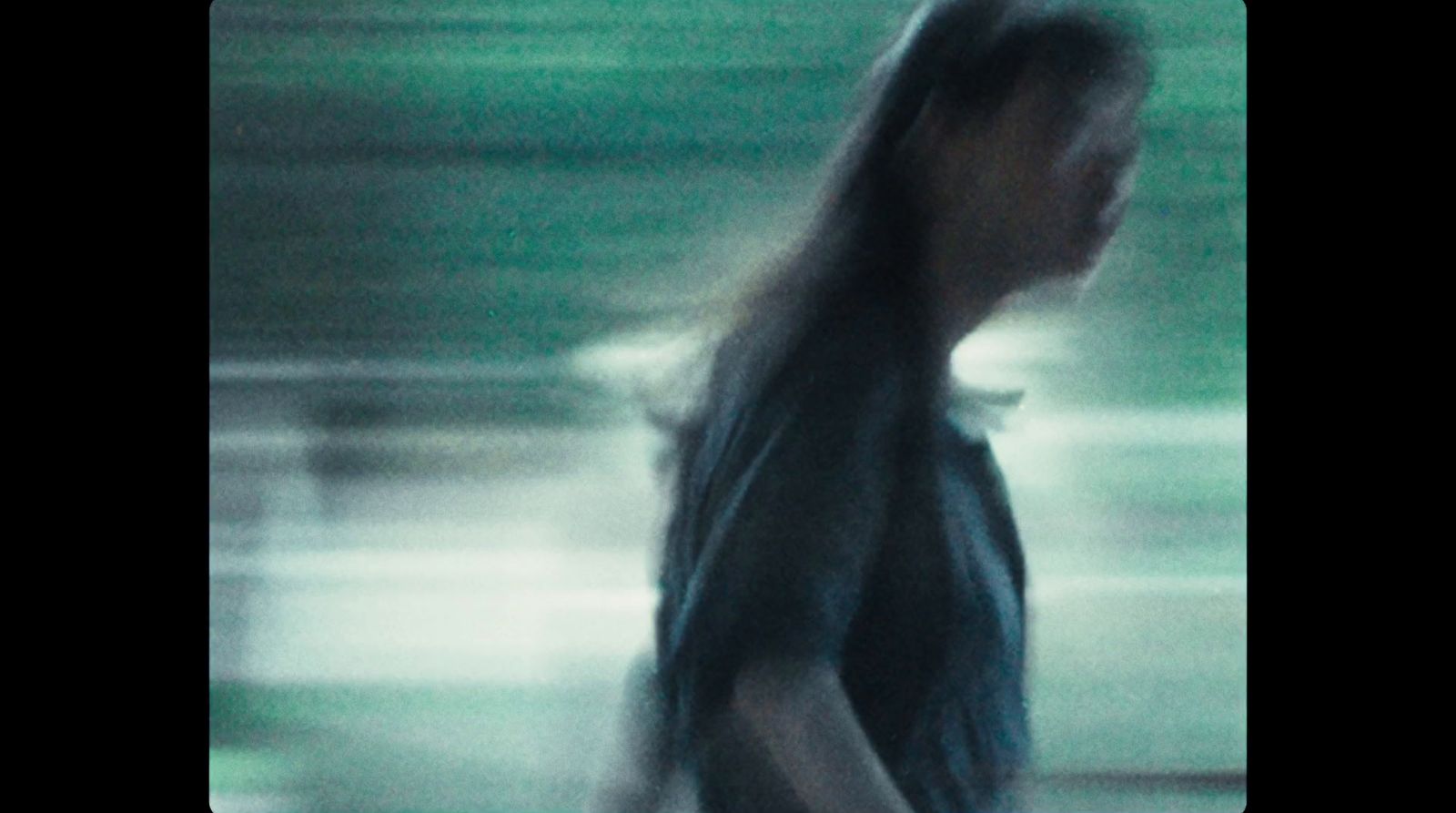 a blurry photo of a woman walking down a street