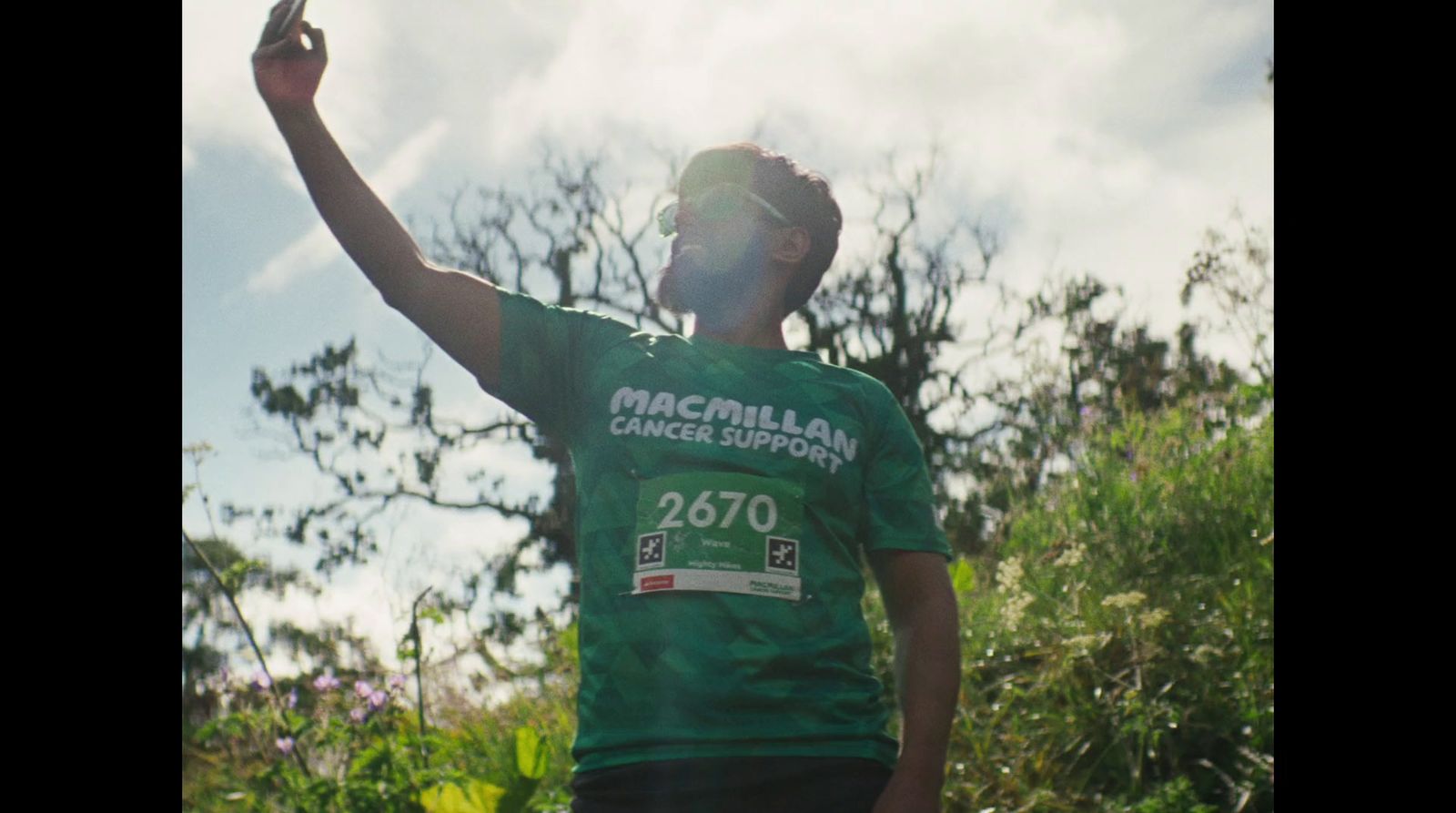 a man in a green shirt throwing a frisbee