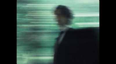 a blurry photo of a man in a suit and tie