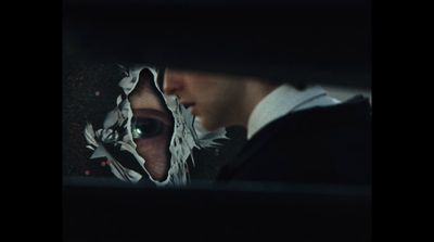 a man and a woman looking at each other through a hole in a piece of