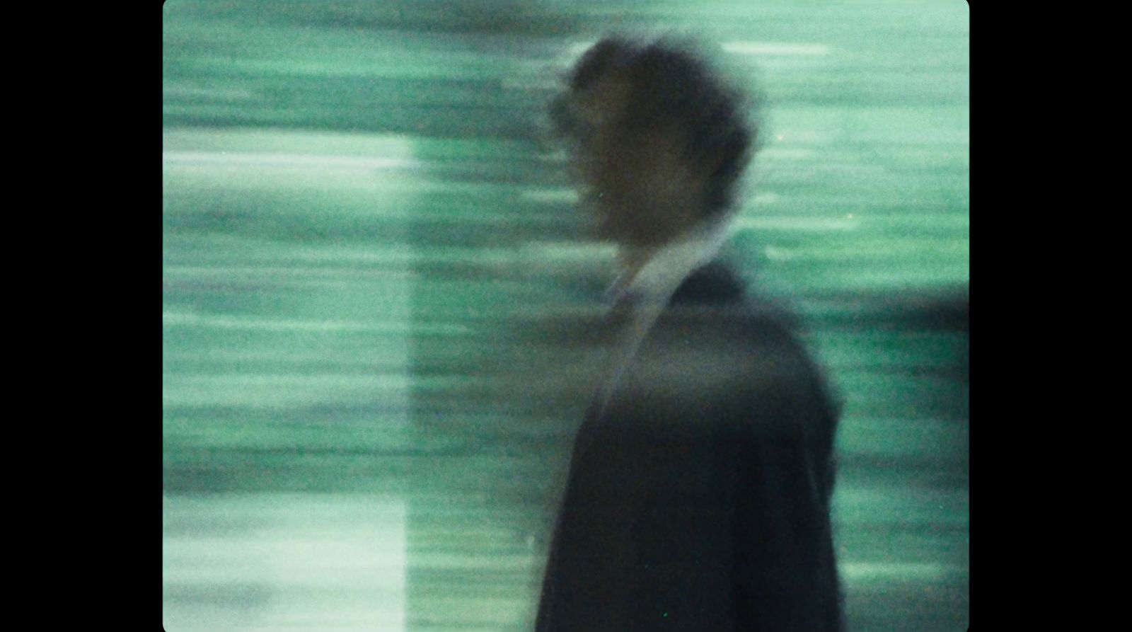 a blurry photo of a man in a suit