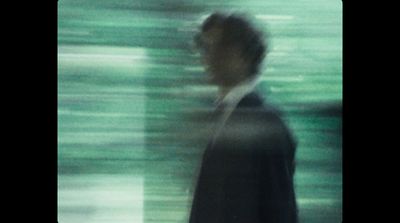 a blurry photo of a man in a suit