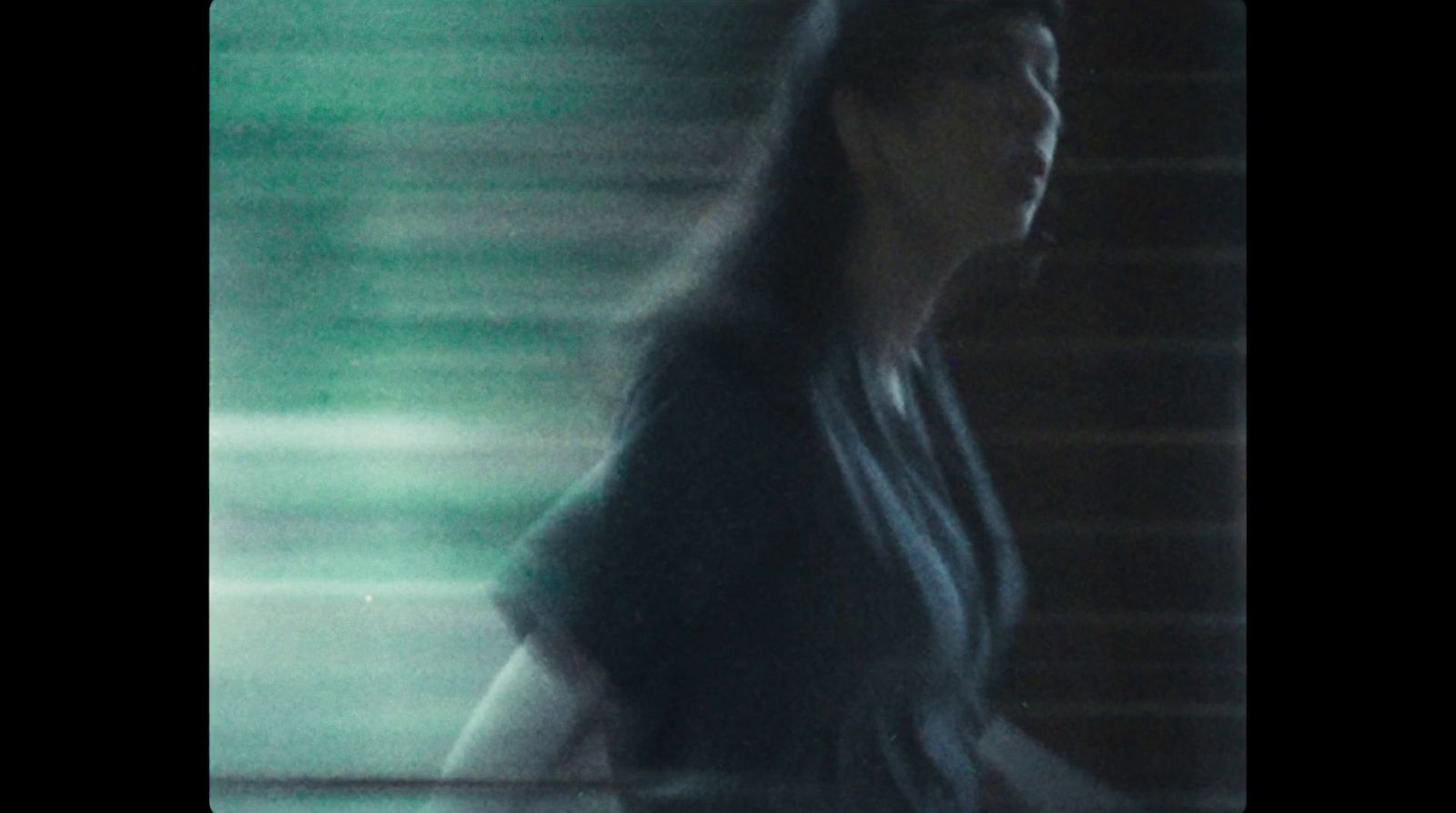 a blurry photo of a woman standing in front of a window