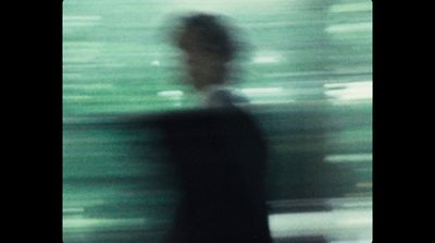 a blurry photo of a man in a suit