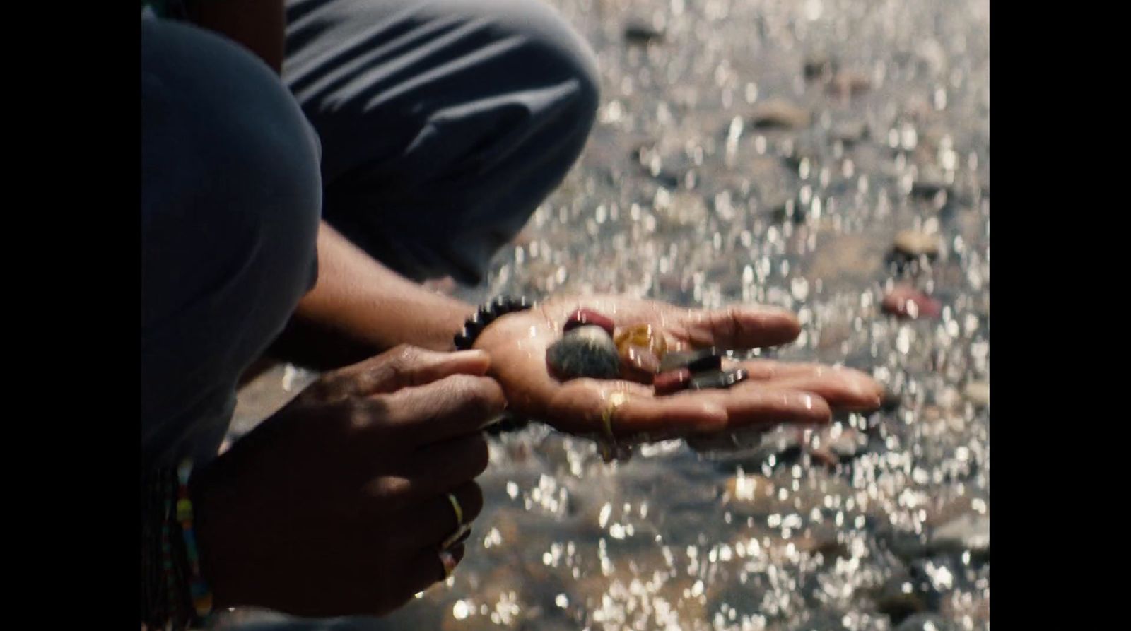 a person kneeling down holding something in their hands