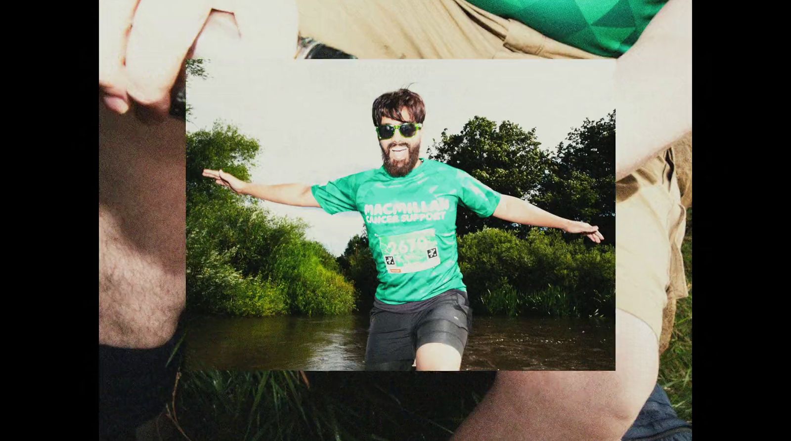 a man in a green shirt is standing in the water