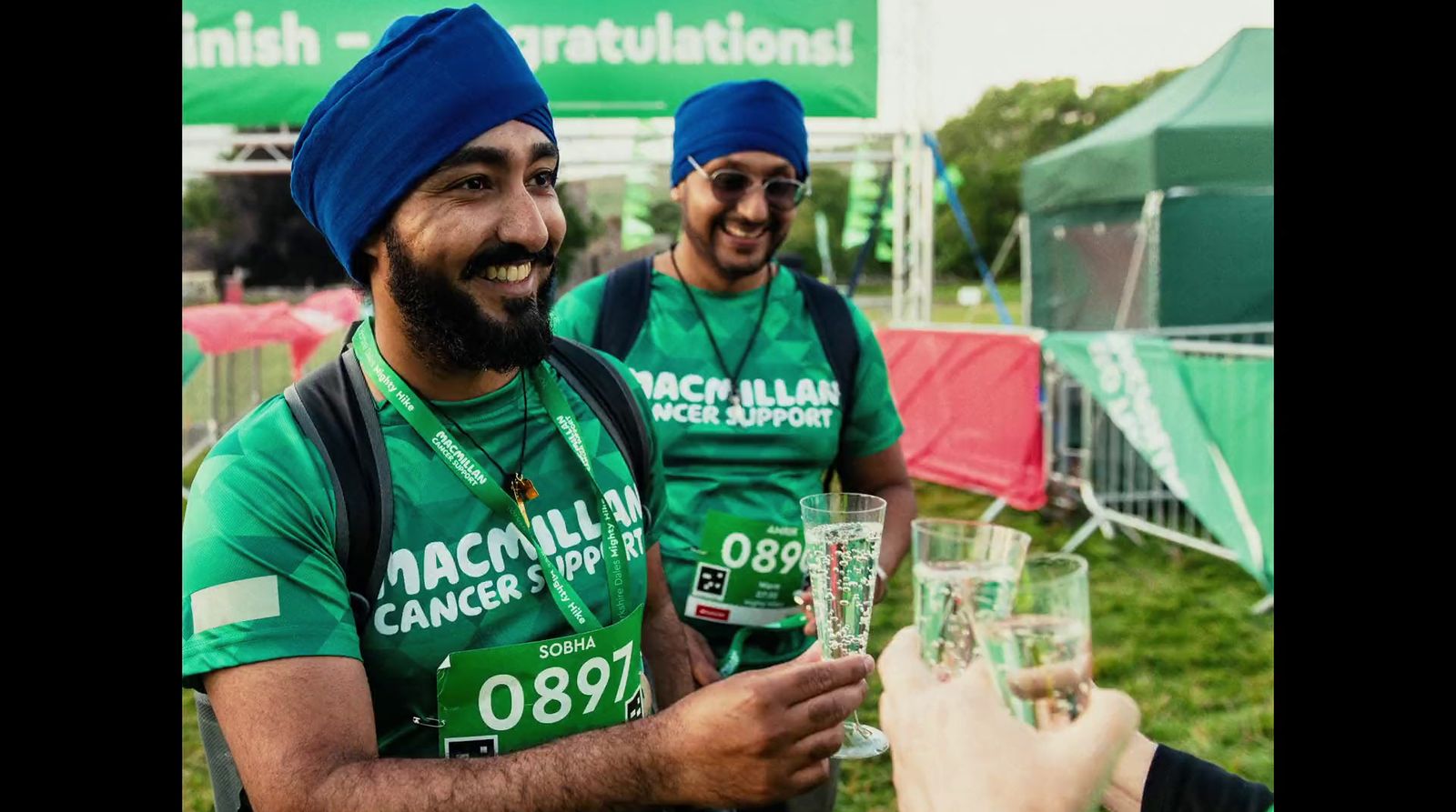 a group of people wearing green shirts and turbans