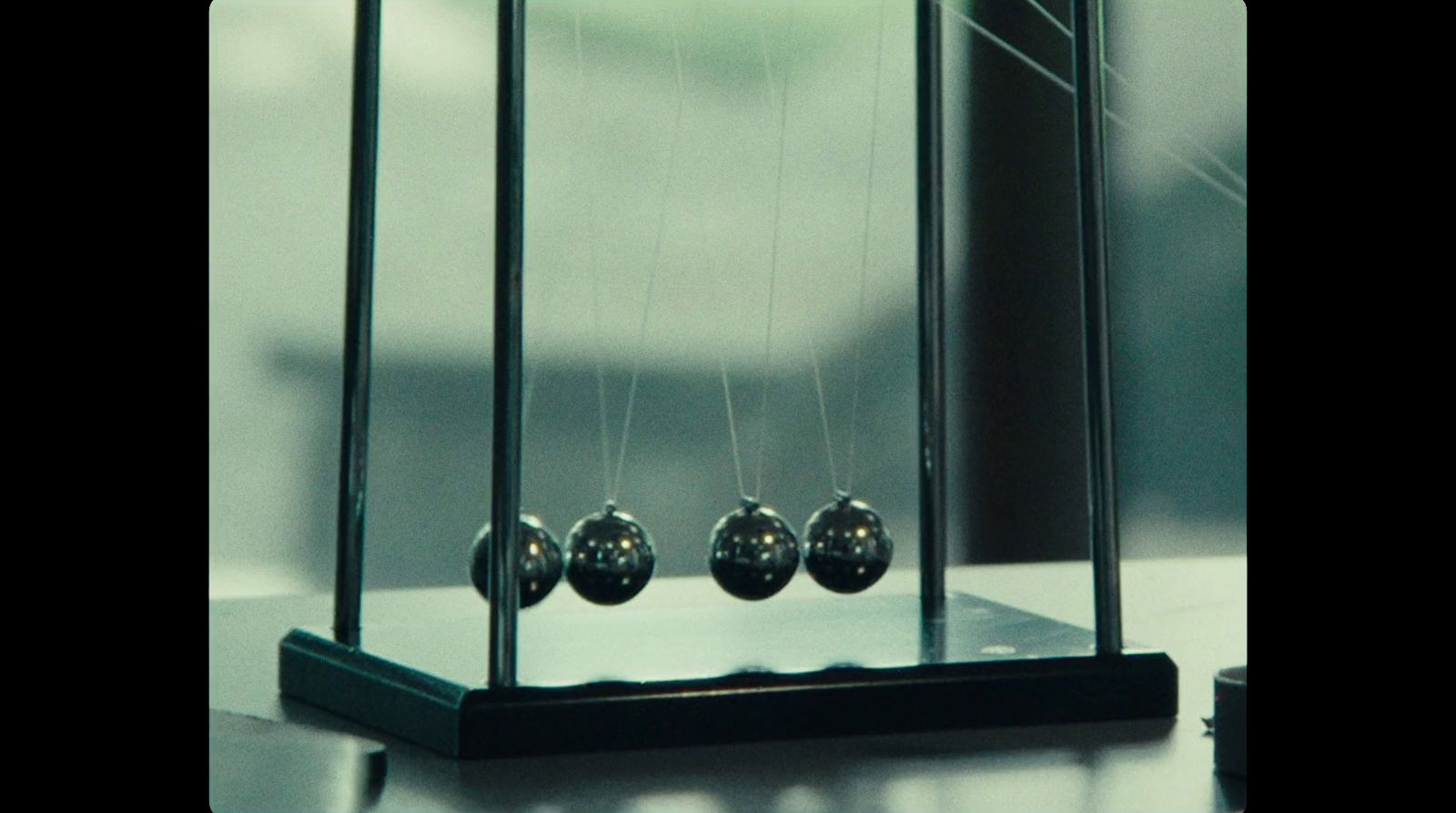 a pendulum clock sitting on top of a table