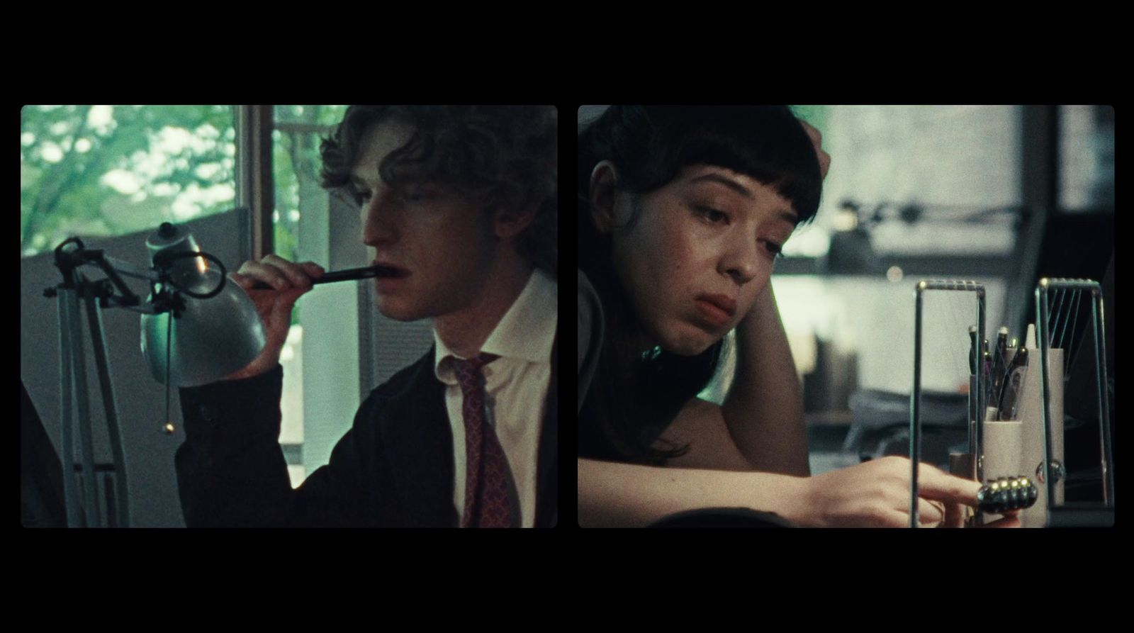 a man in a suit and tie smoking a cigarette