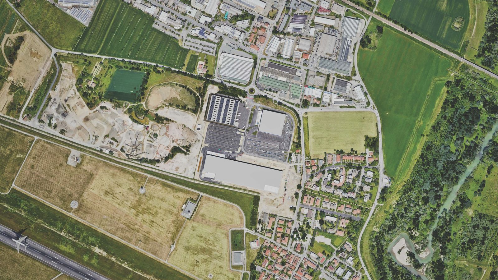 an aerial view of a city with lots of grass