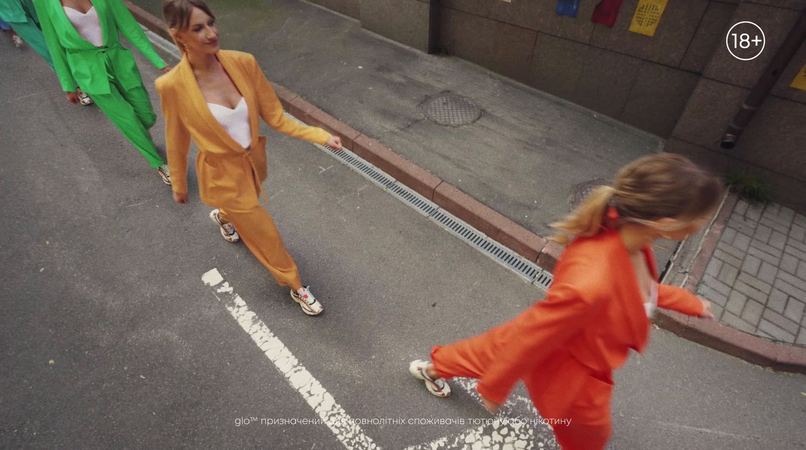 a group of people walking down a street next to each other