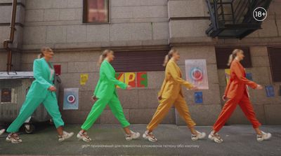 a group of people walking down a street next to a building