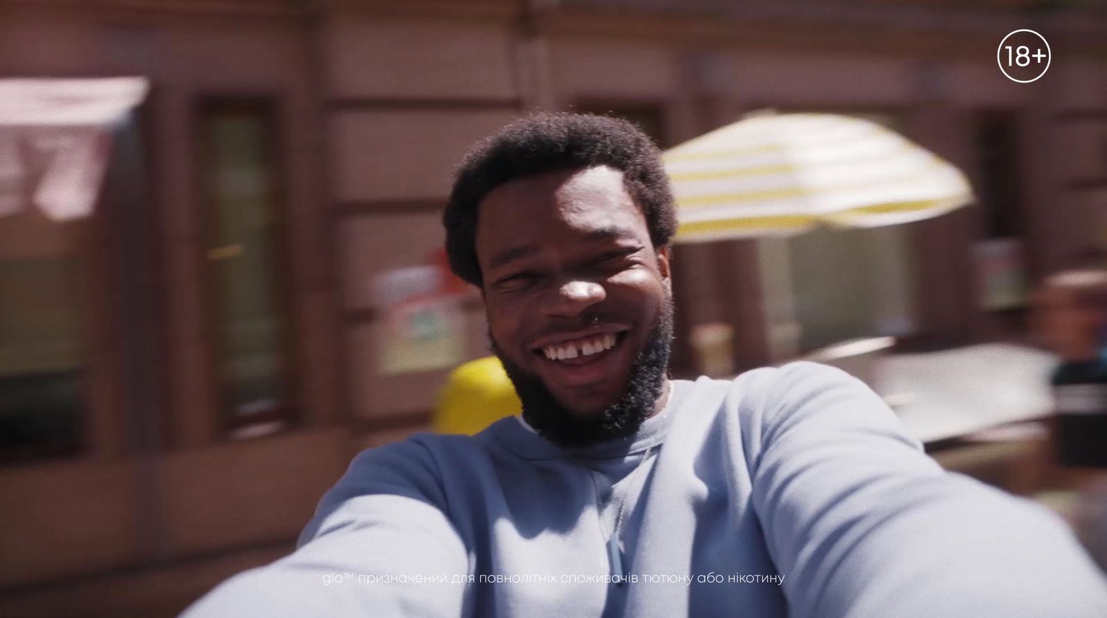 a man taking a selfie in front of a building