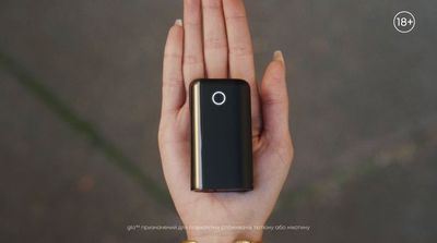 a person holding a small device in their hand