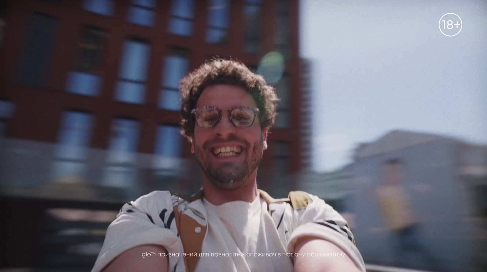 a man taking a selfie in front of a building