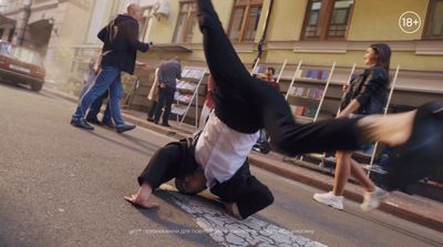 a man doing a handstand on the side of a road