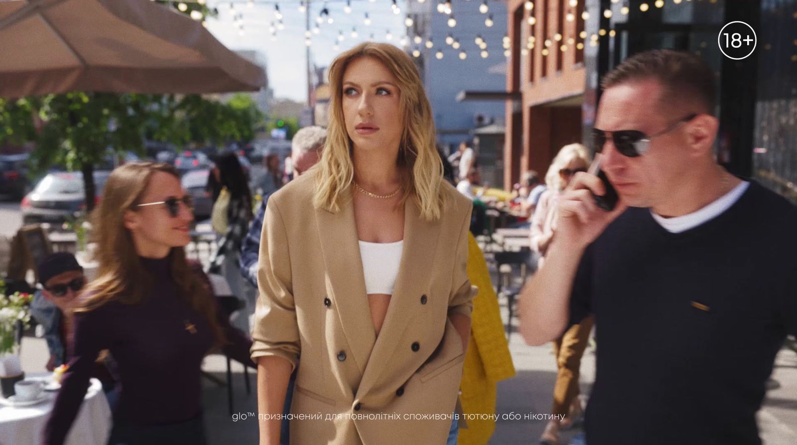 a woman walking down a street while talking on a cell phone