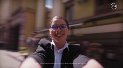 a woman wearing glasses is taking a selfie