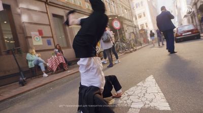 a man doing a handstand on the side of a street