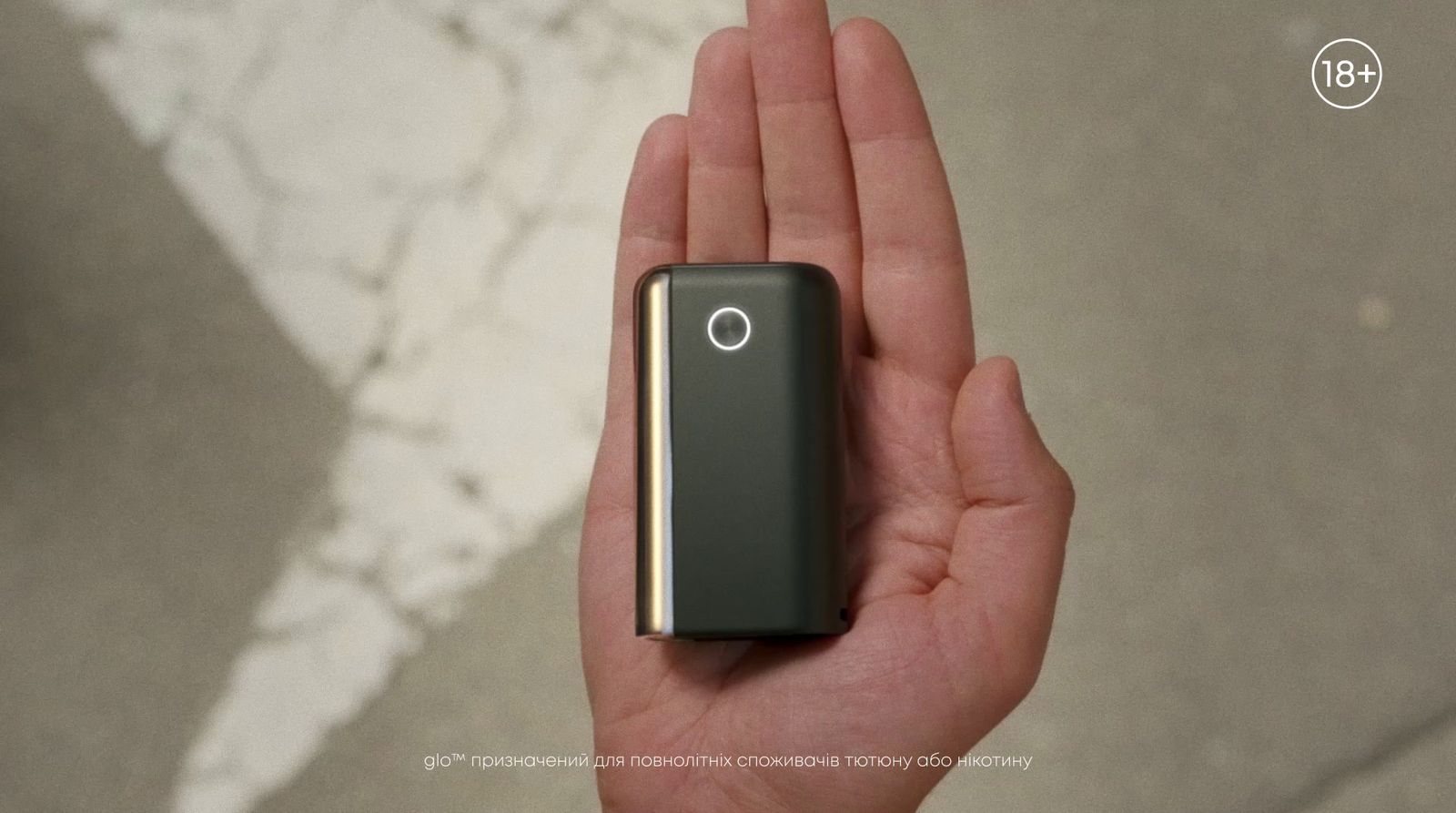 a person holding a small device in their hand