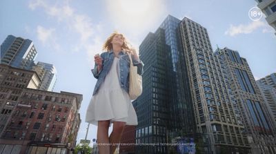 a woman standing in front of tall buildings