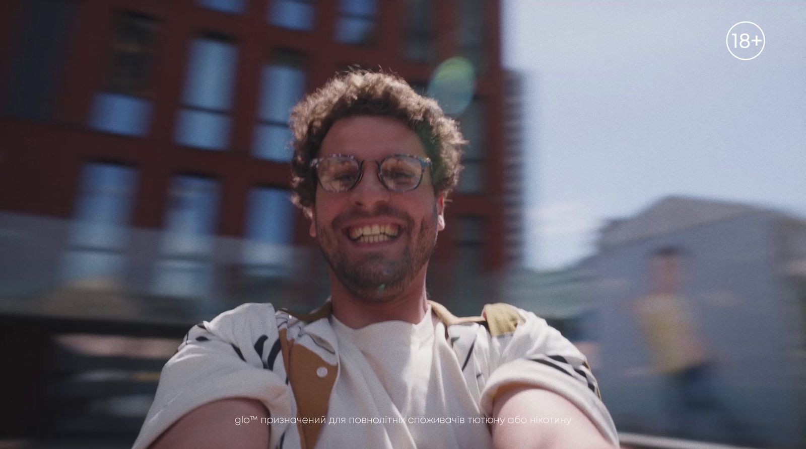 a man taking a selfie in front of a building