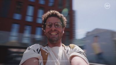 a man taking a selfie in front of a building