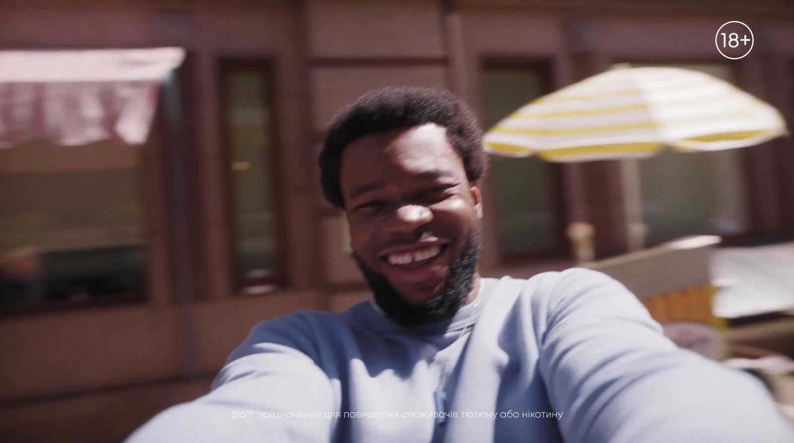 a man taking a selfie in front of a building