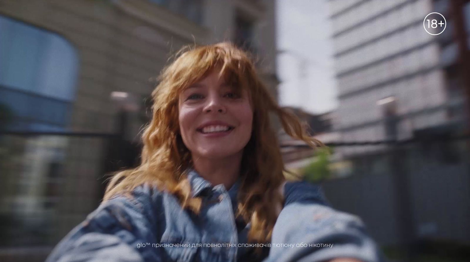 a woman taking a selfie in front of a building