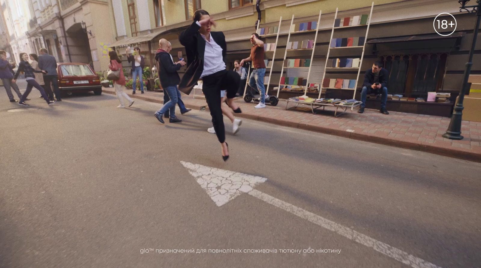 a man is jumping in the air in the middle of the street