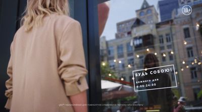 a woman standing in front of a store window