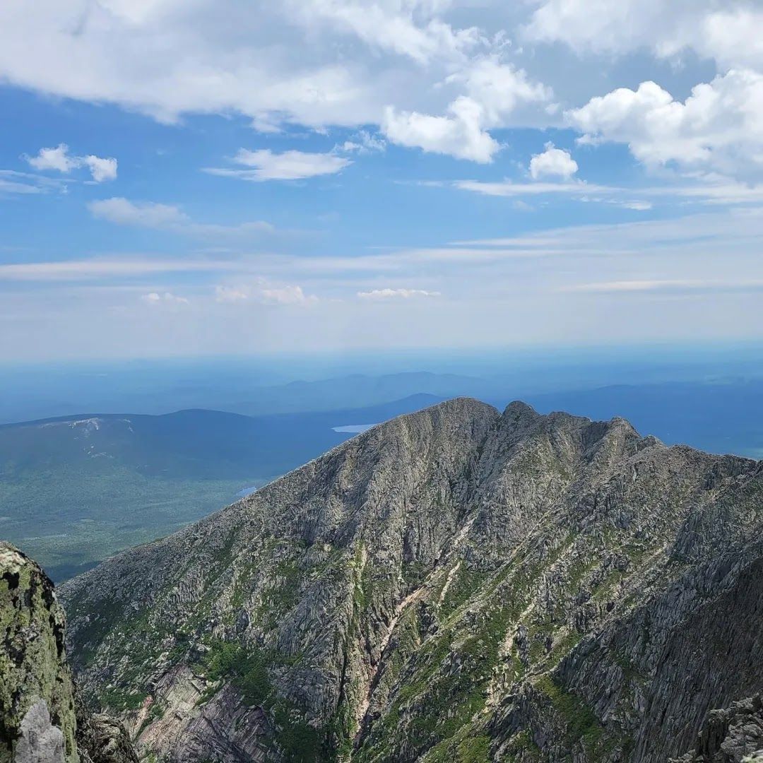 a view of a mountain range from the top of a mountain